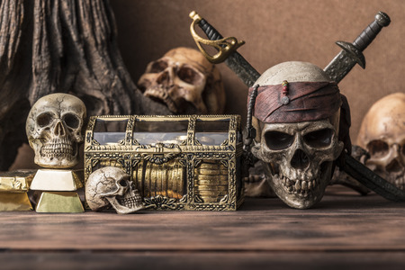 pirate skull and human skeleton with gold and treasure coffer halloween concept still life styleの写真素材