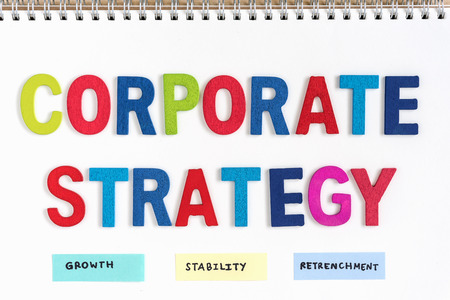 colorful letters wood words corporate strategy growth stability retrenchment on open notebook, top view, business conceptの写真素材