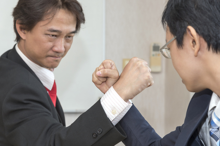 Two Businessman Competing In Arm Wrestling, Competition conceptの写真素材