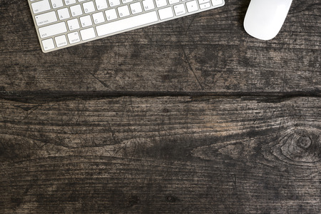 keyboard and mouse on grunge wooden tableの写真素材