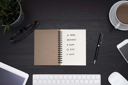 a goal without a plan is just a wish motivational handwriting on notebook with computer, office...