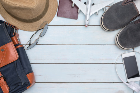 Overhead view of traveler accessories on vintage wooden table with copy space, Essential vacation...
