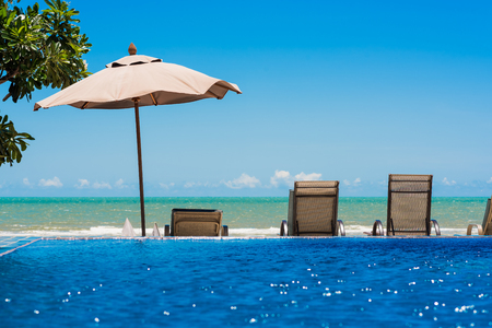 Tropical beach resort with lounge chairs and umbrellaのeditorial素材