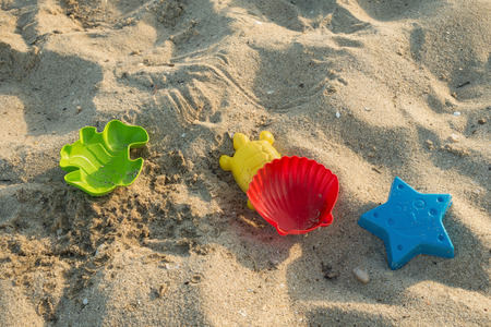 Sandy beach with colorful sand molds of sea creatures.の写真素材