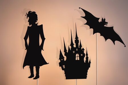 Shadow puppets of vampire, castle and flying bat. Halloween storytelling.の写真素材