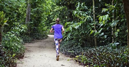 Woman running on trail at Bosque da Freguesia (Freguesia Forest Public Park)