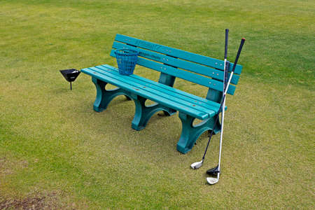 Rio de Janeiro, Brazil - December 11, 2019: Green bench, golf clubs and basket at Golf Course in Barra da Tijuca.のeditorial素材