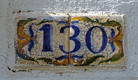 Street sign number 130 on a white wall