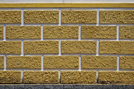 Decorative wall with textured yellow bricksの写真素材