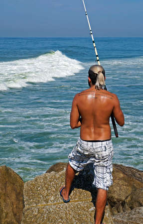 Rio de Janeiro, Brazil - March 25, 2017: Fisherman at Barra da Tijuca beach.のeditorial素材