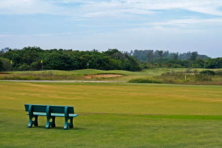 Rio de Janeiro, Brazil - December 11, 2019: Green bench in front of golf course.のeditorial素材