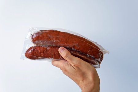 Sausages on hand in a bright backgroundの写真素材