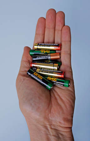 Rio de Janeiro, Brazil - January 23, 2021: Hand holding a set of alkaline batteries.のeditorial素材