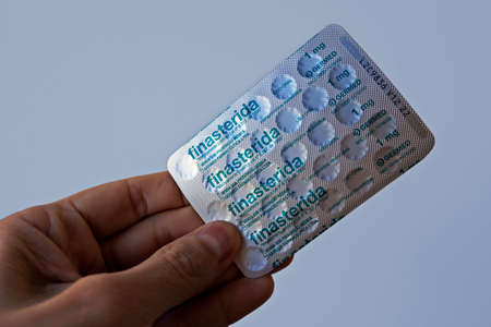 Rio de Janeiro, Brazil - April 30, 2021: Blister pack of finasteride pills on hand.のeditorial素材