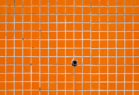 Old orange tile wall texture backgroundの写真素材