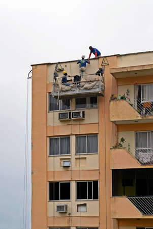 Rio de Janeiro, Brazil - August 03, 2021: Workers repairing a building facadeのeditorial素材