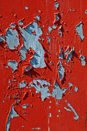 Damaged red metallic surface with peeling paintの写真素材