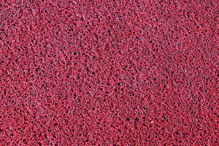 Red synthetic carpet texture backgroundの写真素材