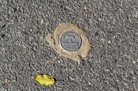 RIO DE JANEIRO, BRAZIL - JUNE 25, 2022: Geodetic mark (sign) on the street in the Itanhanga...