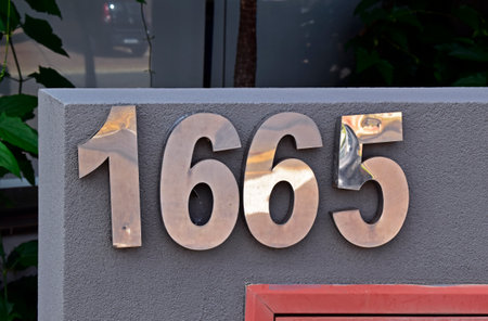 Street sign number 1665 on a building facade