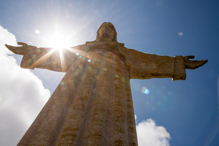 Sun behind Christus Rei Statue  in Lisbon, Portugal, Europeの写真素材