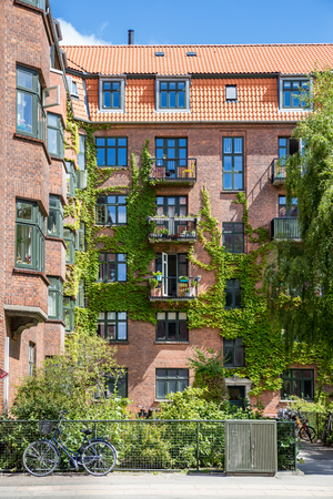Facade of red brick Building with Balconies and Ivy, Copenhagen, Europeのeditorial素材