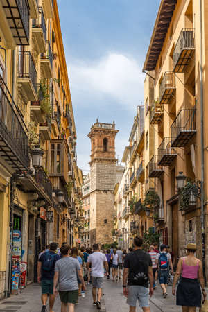 Valencia, Spain â June 23, 2021: Narrow Alley with pedestrians leading to Torre de Sant Bartomeu Tower in Valenciaのeditorial素材