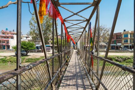The local small metal bridge for cross bagmati river near Guhyeshwari Temple, Nepalの写真素材