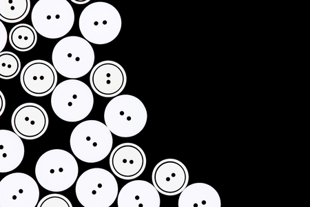 Group of buttons for clothing on a black background.の写真素材