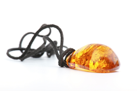 Amber pendant isolated on a white backgroundの写真素材