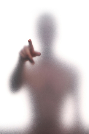 Mystic silhouette of man against the transparent wallの写真素材