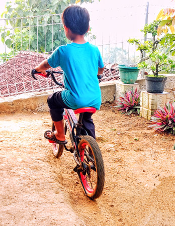 boy is cycling in the yardの写真素材