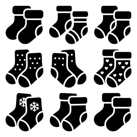 A set of nine black silhouette icons depicting pairs of children's or baby's socks. The collection includes plain, striped, polka dot, heart, and snowflake patterned designs.のイラスト素材