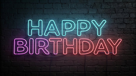 Illuminated Happy Birthday message glows with vibrant neon lights on brick wall.の素材