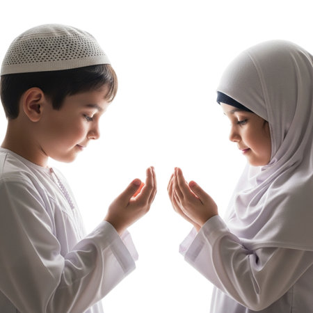 A young boy and girl in traditional Islamic attire sharing a respectful prayer gesture against a black backgroundの素材