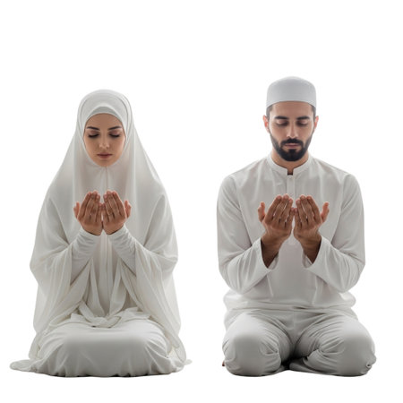 A man and woman in traditional white Islamic clothing praying, kneeling with hands raised, on a black backgroundの素材