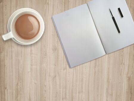 top view table desk. Workspace with blank notebook,pen and coffee cup on wood background , clipping pathの写真素材