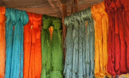 Colorful Dyed Cloth Tied in Knots on a Rackの写真素材