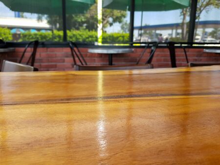 blurred background with wood table at coffee cafeの写真素材