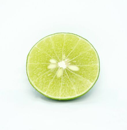 green fresh lime slice isolated on white backgroundの写真素材