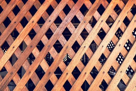 Diagonal crossed wooden planks background. Wooden battens Background. Old lath overlap.の写真素材