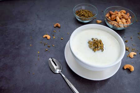 Bowl of cereal matcha oat granola with oat milk, cashew nuts on Black Background. vegan foodの写真素材