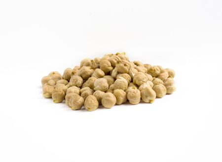 Dry raw organic chickpeas isolated on white background. Chickpeas in a pileの写真素材