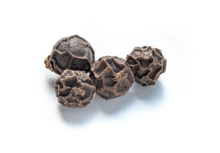 close up macro shot Black peppercorns (Black pepper) isolated on white background.の写真素材
