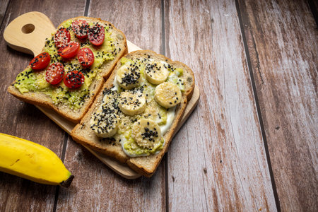 Healthy breakfast toasts with Avocado toast, tomato, banana, Yoghurt with whole grain sandwich bread. Concept of healthy eating, dieting, vegan vegetarian foodの写真素材