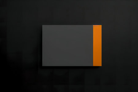 Mockup of a black and orange business card on a black backgroundの写真素材