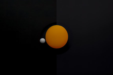 3d rendering of a black background with an orange ball in the centerの写真素材