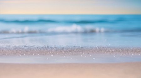 Close up of sea wave on sandy beach with bokeh backgroundの写真素材