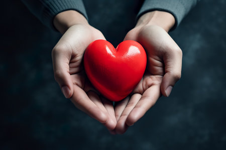 hands holding red heart, health care, love, organ donation, mindfulness, wellbeing, family insurance and CSR conceptの素材