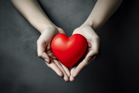 hands holding red heart, health care, love, organ donation, mindfulness, wellbeing, family insurance and CSR conceptの素材
